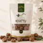 Kalimpong Ko Khattu dried and coated jujubes in a premium Dokos stand-up pouch with scattered fruits on a clean beige background.